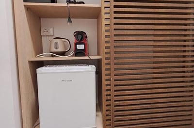 a small refrigerator with a microwave and a microwave