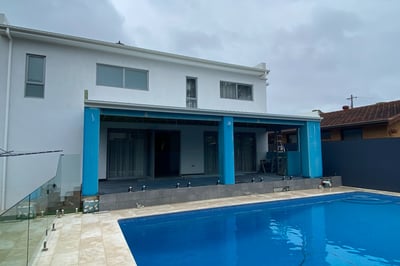 foreground pool with modern home extention in progress