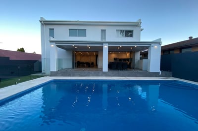 foreground pool with midground modern outdoor area