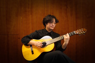 a woman playing a guitar in a room