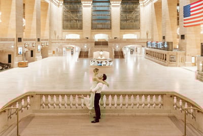 a bride and groom standing on a staircase way on the Grand Central Station
