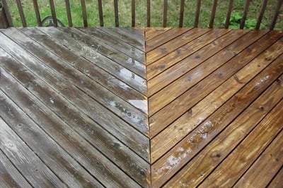 Before and after pressure washing a dirty wood deck