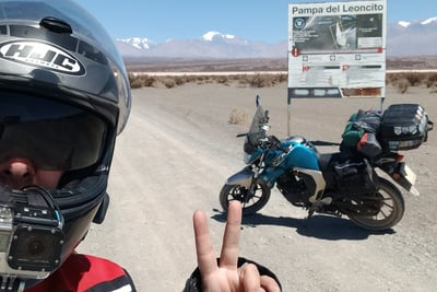a man in a helmet and helmet on a motorcycle