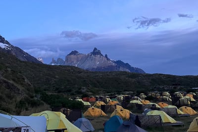A tent pitched up in Paine Grande campsite with Cerro Cuerno Principal 