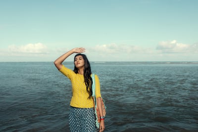 a woman in a yellow top and blue skirt