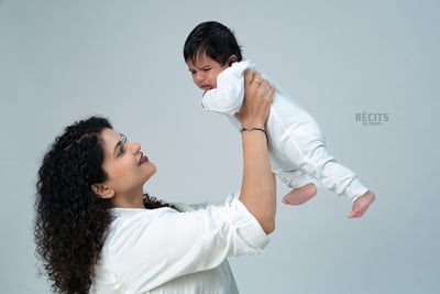 a woman holding a baby in her arms