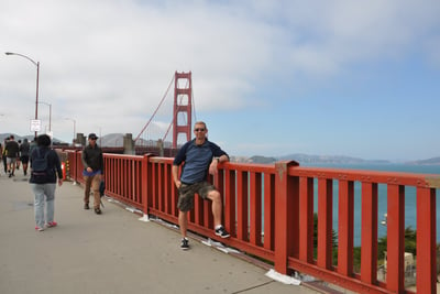 a man standing on the golden gate bridge over looking at the golden gate bridge