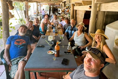 a group of people sitting at a table with drinks