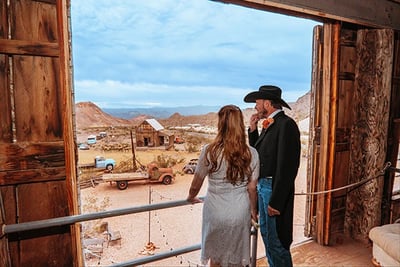 a man and woman standing in front of a door