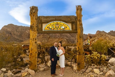 a man and woman standing in front of a stained glass window