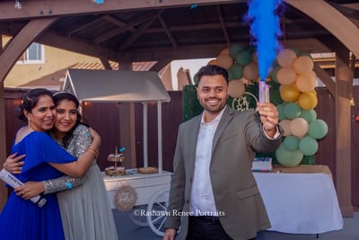 a man and woman standing in front of a party for baby shower