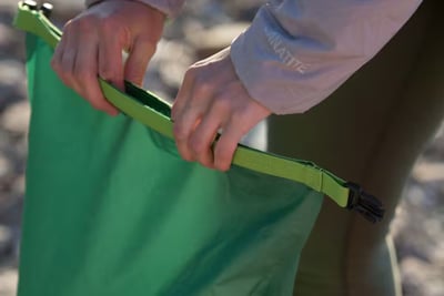 camping dry bag being folded