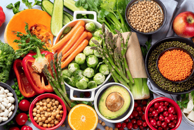 a variety of vegan food including fruits and vegetables in bowls