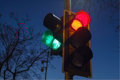 Intelligent traffic light glowing red and green at night, used in adaptive signal control systems.