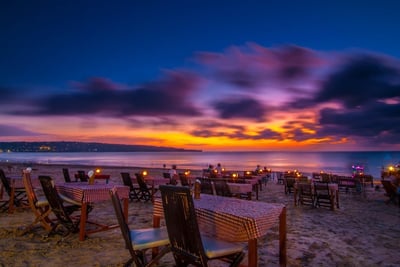 a beach with a table setting for dinner