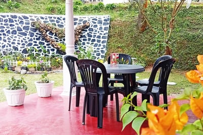 Outdoor dining area at Nobel Bungalow Nuwara Eliya with flowers and garden view
