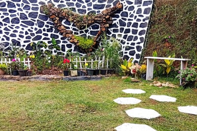 Pond and flower garden with bench at Nobel Bungalow Nuwara Eliya – peaceful outdoor space