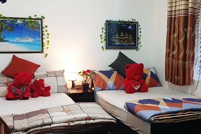 Family room at Nobel Bungalow Nuwara Eliya with double beds and red teddy bears