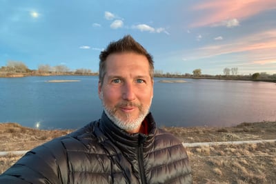 Warm, grounded presence of a guide offering transformational sessions