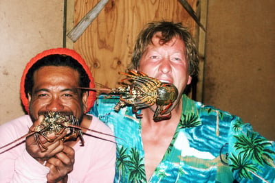 Janne and local man eating lobsters in French Polynesia