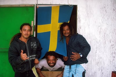 Three local guys with Swedish flag in Raroia, French Polynesia