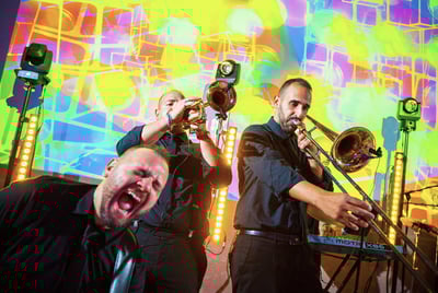 Energetic brass section performing on stage during wedding show