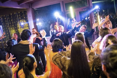 Wedding band interacting with dancing guests during a live show