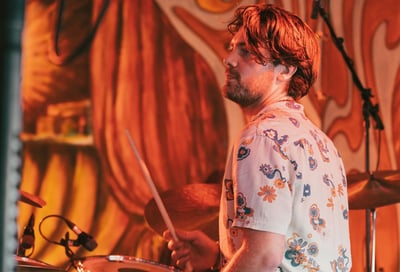 a man playing drums on a stage