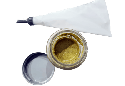 a jar of pistachio cream and a white pastry bag