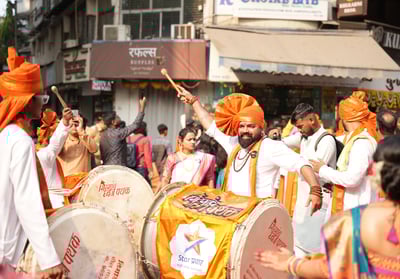 man playing dhol  in girgaon gudipadwa shobhayatra 2025