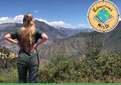 a teacher standing on a mountain top overlooking the valley below