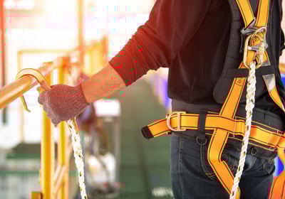 Worker wearing fall protection gear
