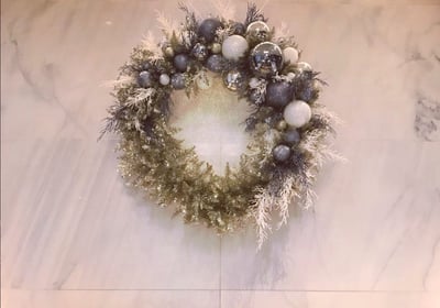 Andy Albright's wreath design hanging on a wall.