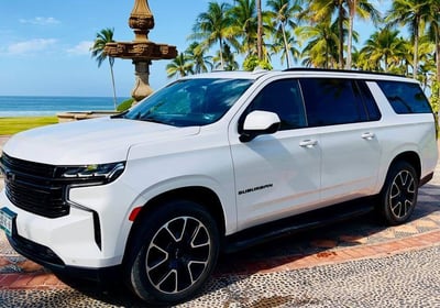 a white suv parked in front of a fountain