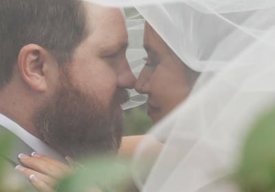 Bride and groom under a veil