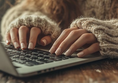 a woman's hands on a laptop computer