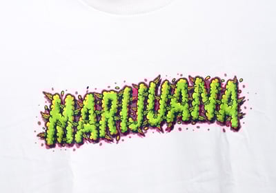 a white t - shirt with the word marijuana on it