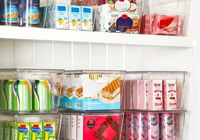 an organized pantry with a variety of different types of food in bins