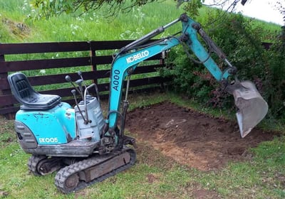 Small digger and scrapped off garden as an example of plant hire available