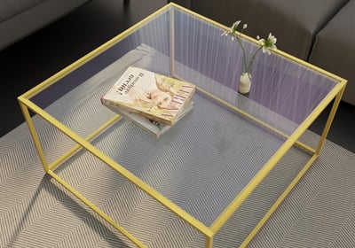 a glass table with a magazine and a magazine