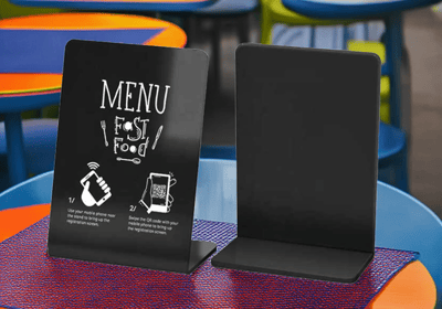 Small NFC display stand on table of a fast food restaurant, showing menu and promo content.