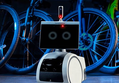 Surveillance robot with tablet face in bike shop. Business tech and security protection solution.