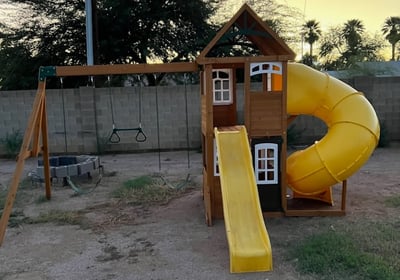 a playground with a slider and a slider