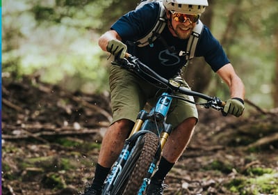 a man riding a bike in the woods