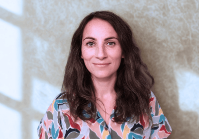 a woman in a colorful shirt and jeans