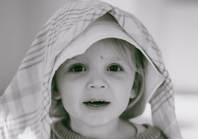 Children playing and laughing during a natural photo shoot in Essex.