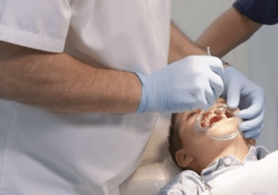a man in a white shirt is getting ready to be a dentist