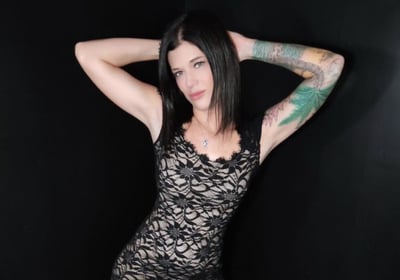 a woman Harley Brooks with tattoos on her arm and a tattoo on her arm