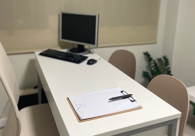 a desk with a computer and a keyboard