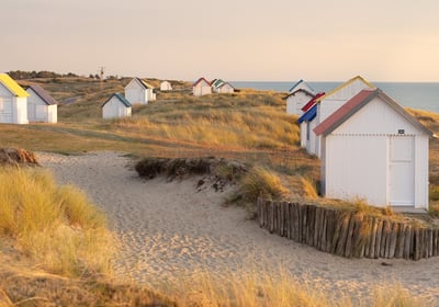 a beach with a fenced in area with a fence and shop